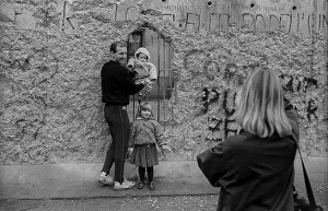 GDR, Berlin, 11.1.1990, tourists taking photos of themselves at the Wall at the Brandenburg Gate