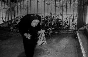 GDR, Berlin, 8.2.1990, old woman feeding the pigeons at Prinzenstrasse underground station