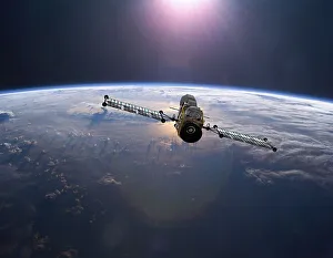 Geostationary orbit military satellite above the Earth pointed toward the rising sun