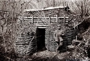 German soldier in front of an earth bunker