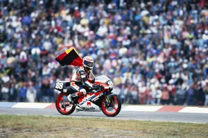 The German Waldi Ralf Waldmann, Team Schuh, Zwafink, Honda, 125 cc, celebrates his first Grand Prix victory with the German flag at the Motorcycle World Championship at the Hockenheimring on 26 May 1991 in Germany