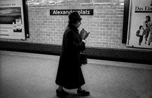Germany, Berlin, 14.02.1992, Woman with hat and newspaper, underground station Alexanderplatz, Europe