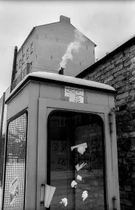 Germany, Berlin, 19.02.1991, smoking telephone box (GDR)