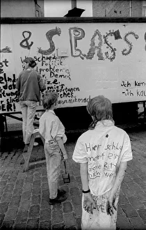 Germany, Berlin, 27.04.1991, Children painting a construction trailer in Oderberger Strasse