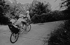 Germany, Berlin, 27.06.1991, Tandem bicycle with two children and one adult