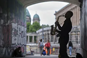 Germany, Berlin, 29.06.2023, Saxophonist in the tunnel of the S-Bahn bridge over the river Spree