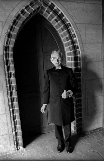 Category Historic Photos EN Prints: Germany, Stepnitz, 30.04.1992, Pastor with candle in front of the church in Stepnitz