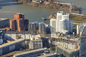 Ghery buildings in the Dusseldorf media harbor with the Dusseldorf city gate in Dusseldorf in North