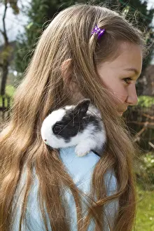 Framed Print : Girl, 10 years old, with a pet rabbit
