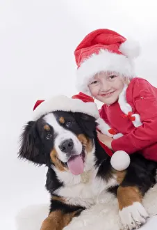 Girl and dog with Christmas hats