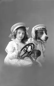 Girl with dog behind the wheel