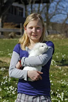 Girl holding a rabbit in her arms