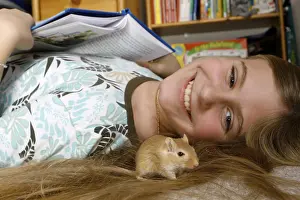 Girl and Mongolian gerbil (Meriones unguiculatus)