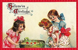 Girl playing apple bobbing, apples in a barrel with water