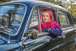 A girl with post-war classic car