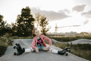 Girl with roller skates on a skating rink