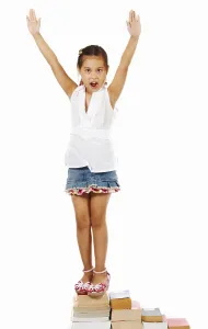 Girl Showing Her Achievement By Climbing Her Books