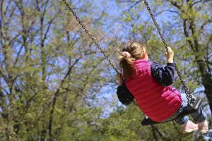 Girl swinging on a playground