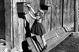 Girl trying to reach mailbox, ca