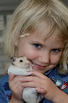Girl, four years old, with a hamster