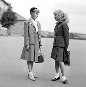 Girls in the 1950s. Two teenage girls dressed in outfits typical of the decade