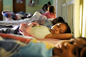 Girls going to sleep in the dormitory of an orphanage