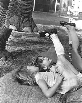Two girls playing with an elephant