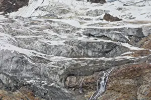 Glacier landscape with snowfields and waterfalls flowing over rocks