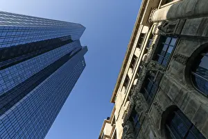 Glass facade of Deutsche Bank, next to it facade of an old house