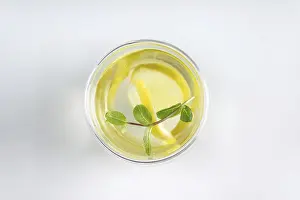 A glass of water, lemon and mint