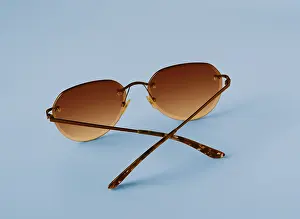 Glasses with orange lenses on blue background