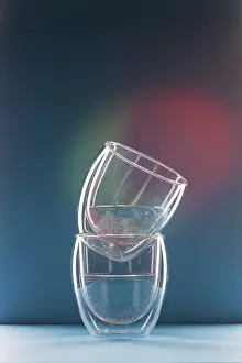 Two glasses with water on a colorful background with copy space