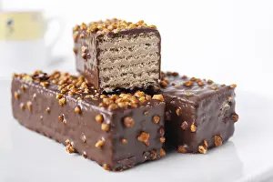 Glazed wafer bars with nuts on a white background