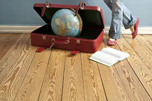 Globe in a suitcase, book, legs
