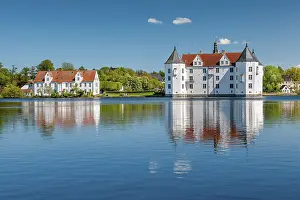 Glucksburg moated castle under a blue sky with white clouds