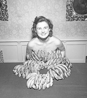 Going bananas in the 1950s. A young woman covers herself with bananas