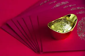 Gold ingot on top of Chinese New Year packets