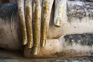 Gold leaf covered fingers of big Buddha statue in Sukhothai