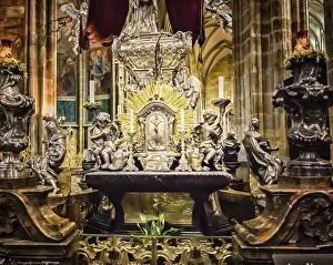 Golden altar with statues and catholic objects and symbols inside Saint Vitus Cathedral in Prague