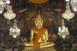 Golden Buddha statue, Phra Buddha Trilokachet surrounded by crystal chandeliers and exquisite wall paintings