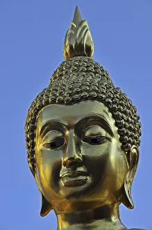 Golden Buddha statue with flame of enlightenment