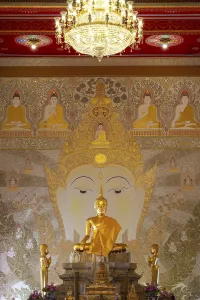 Golden Buddha statue with tunic