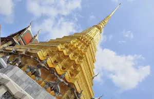 Golden chedi reaching for a bright blue sky