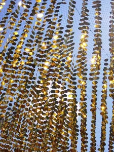Golden garlands shine in the sun as a background