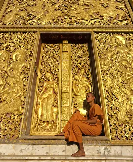 Golden reliefs, monk at the entrance to the Carriage House