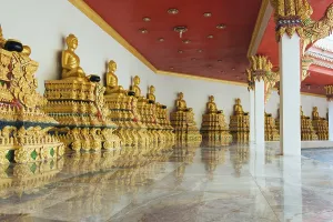 Golden statues of Buddha in a mountain temple