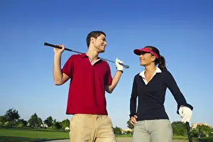 Category Historic EN Prints: Golf course young happy players couple talking posing on bunker