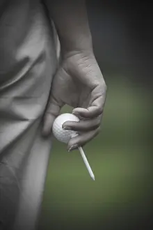 Golfer Holding a Golf Ball and a Tee, Switzerland