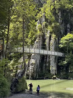 Gorge with a footbridge, steep cliffs and walkers