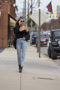 A gorgeous blonde model poses outdoors while enjoying the fall weather